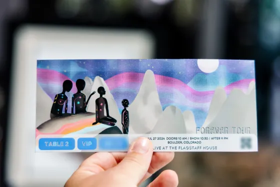 “Forever Tour” ticket showing star-speckled figures on a mountain under an aurora